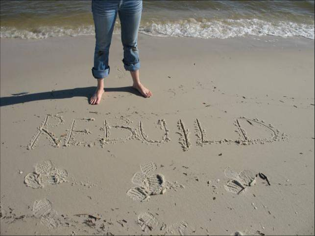 rebuild by Jewish Women's Archive le mot rebuild écrit dans le sable